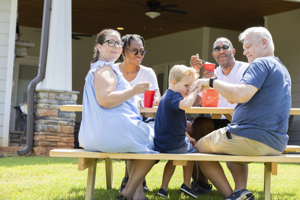 Family gathered at a picnic table on the farm