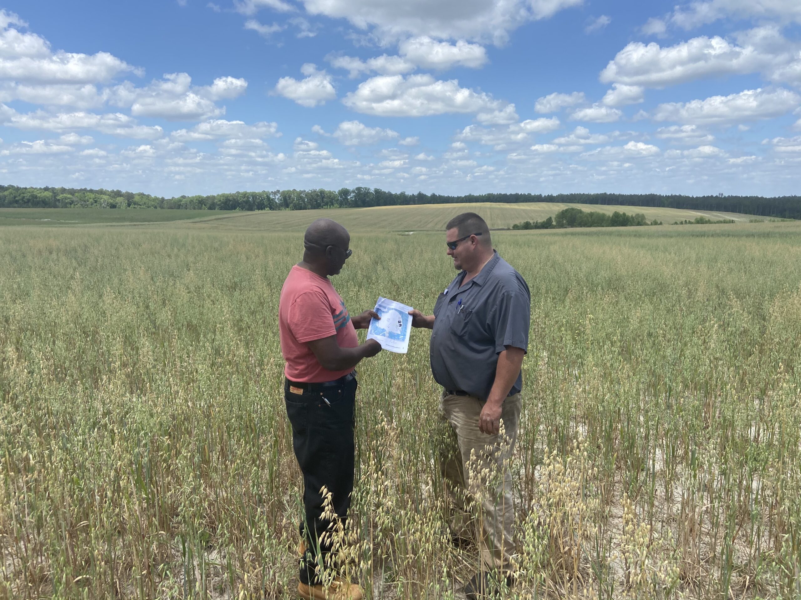 Two people reviewing a soil map in a field at Wandalands