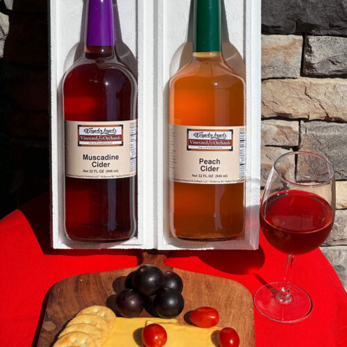 Two bottles of Wandalands muscadine cider